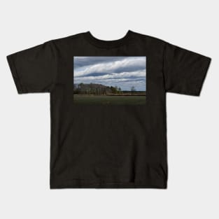 Clouds over farmland Kids T-Shirt